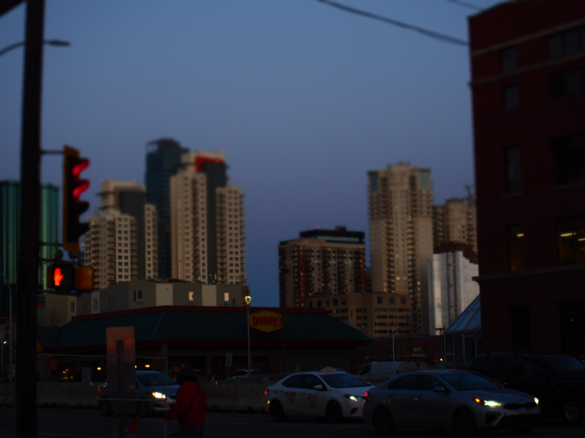 high-rise buildings beyond a street intersection at blue hour in edmonton