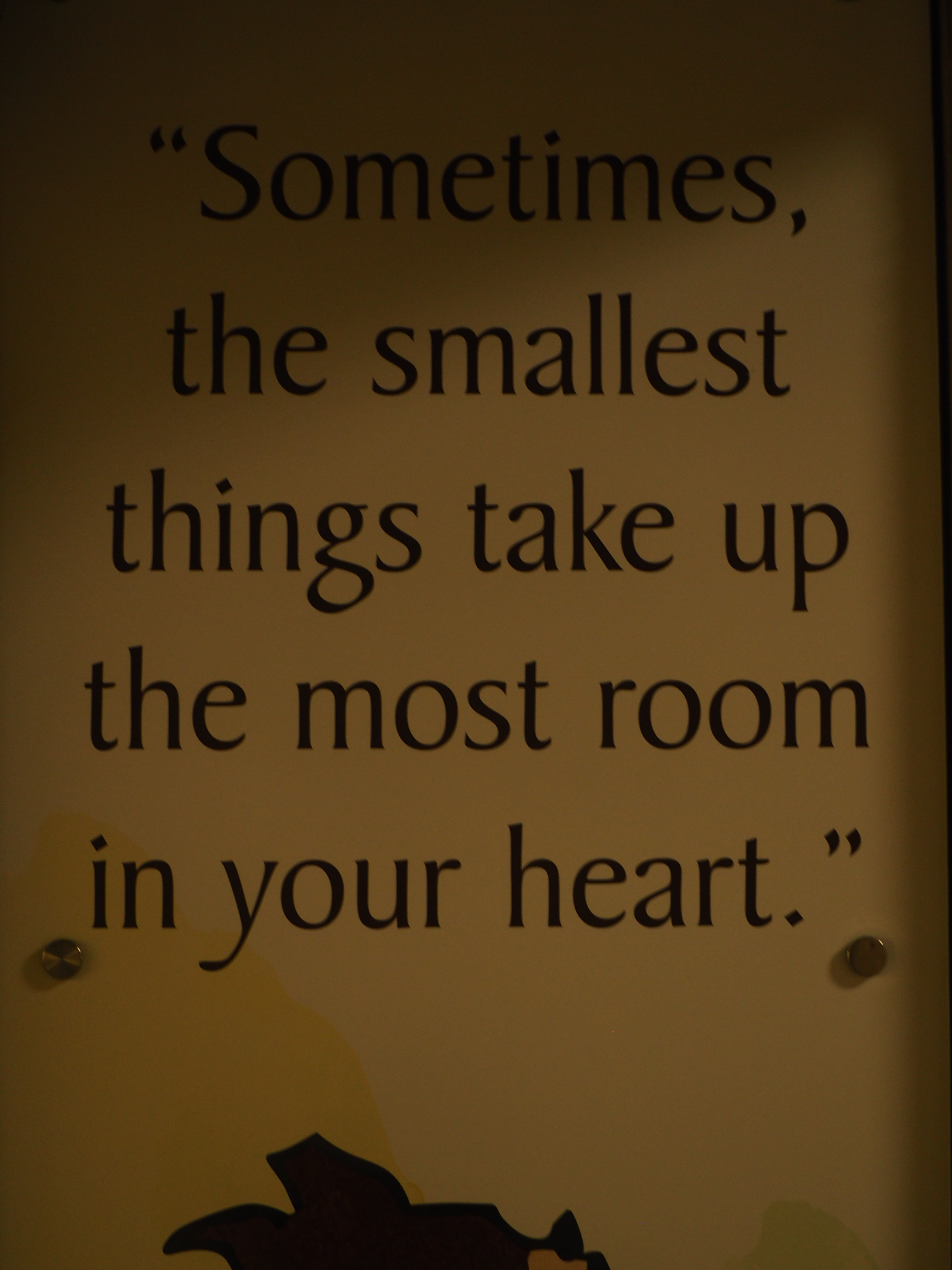 warm yellow quote sign reading sometimes the smallest things take up the most room in your heart