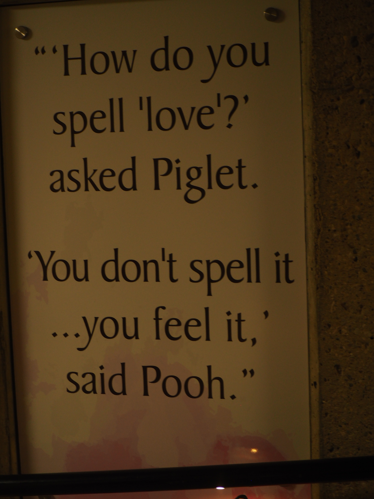 painted garden sign with a quote saying love is something you feel