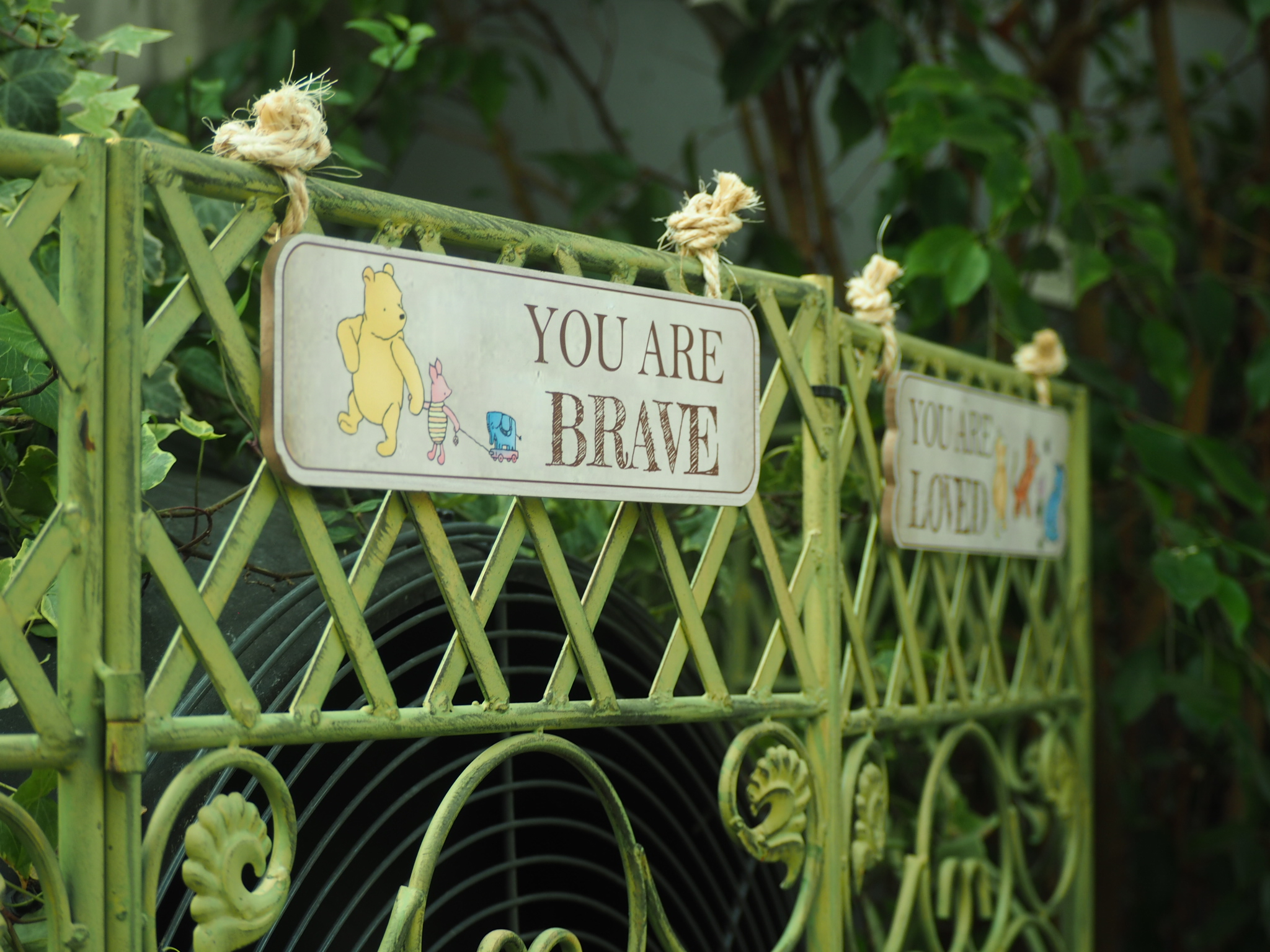 decorative garden gate sign reading you are brave near edmonton