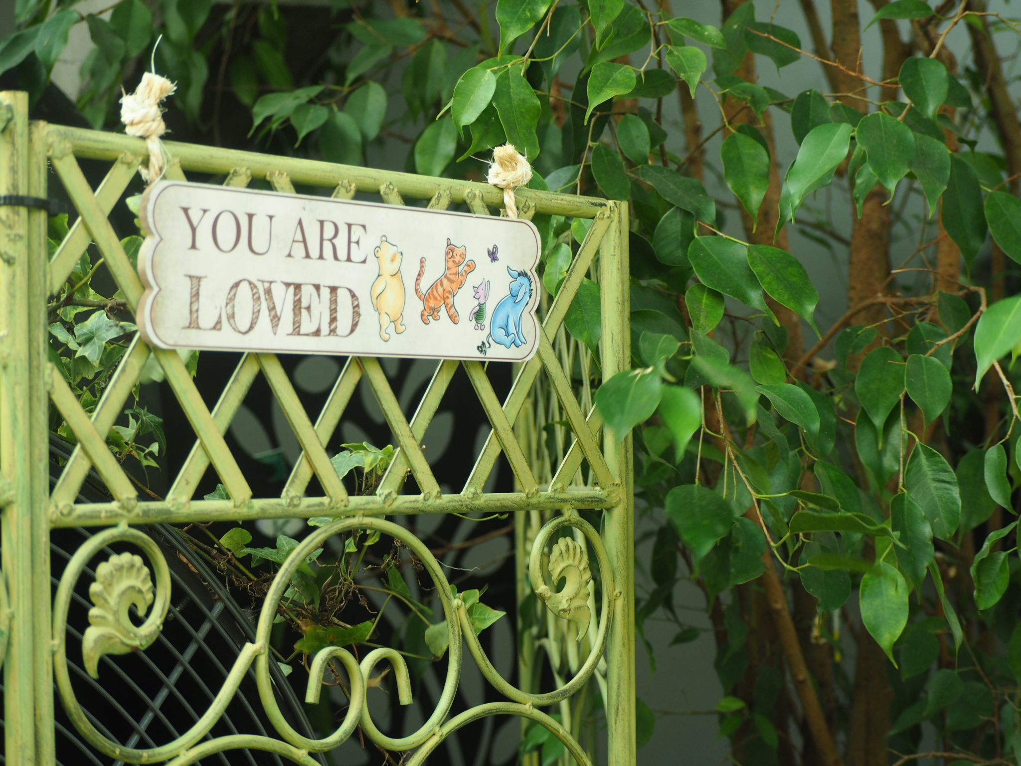 decorative garden gate sign reading you are loved near edmonton