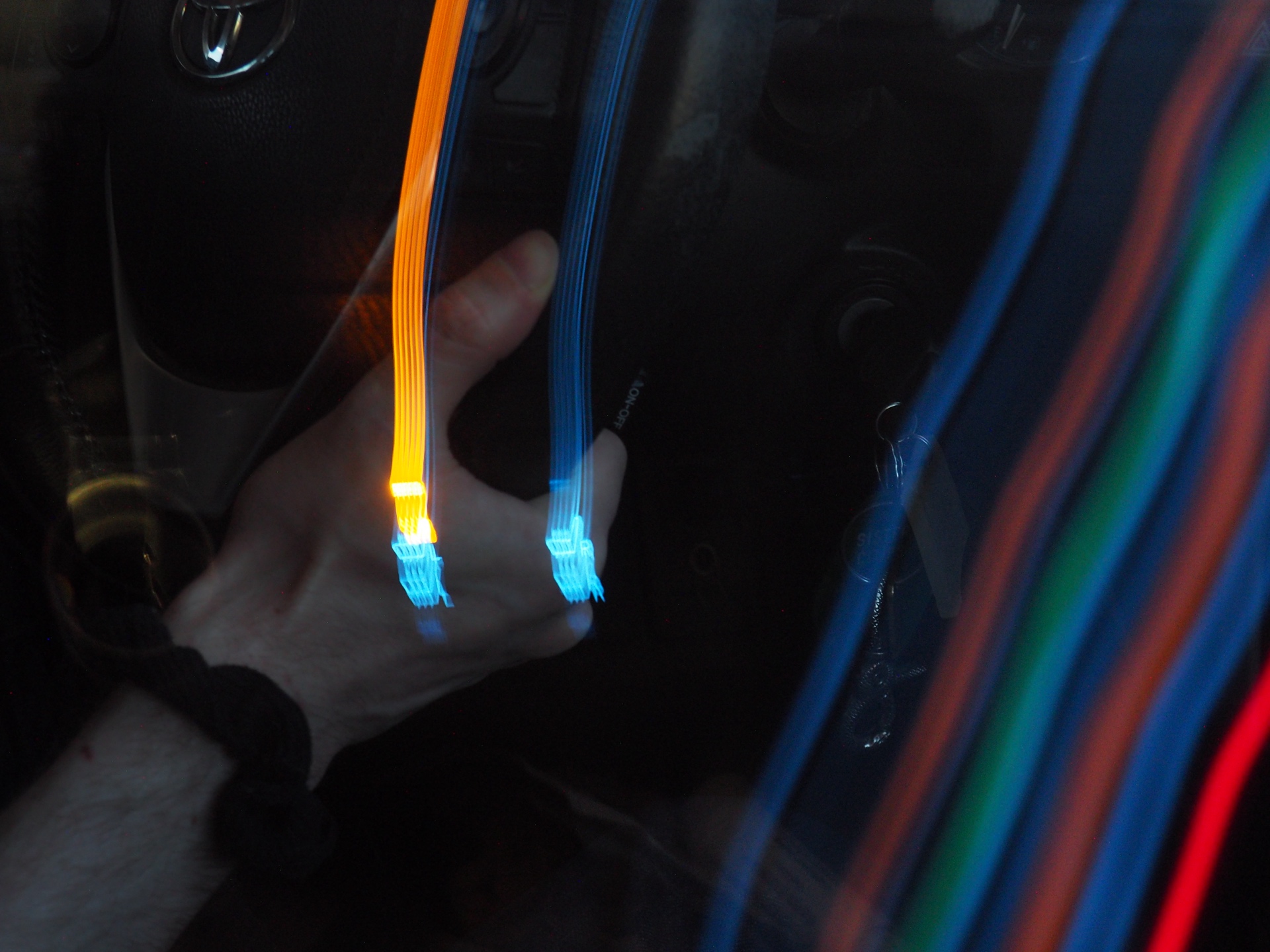 abstract blue orange and red light streaks across a dark frame